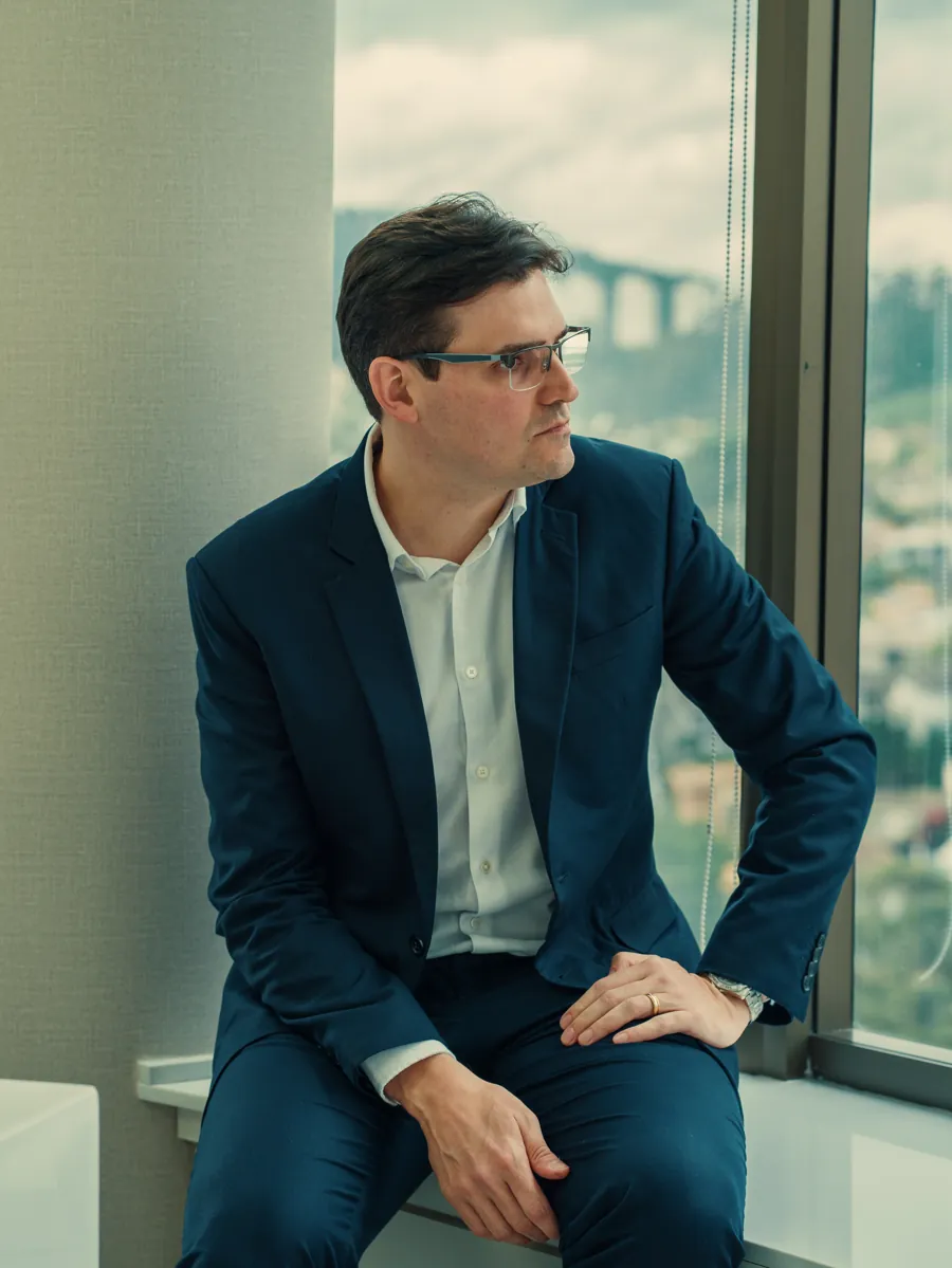 Dr. Alexandre Antonaccio em seu consultório, olhando pela janela
